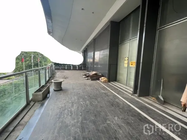 Retail Space for rent in Sathon, Bangkok - Covered walkway balcony with glass railing and large storefront panels.