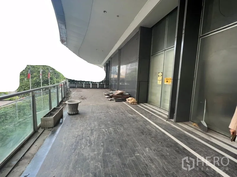 Retail Space for rent in Sathon, Bangkok - Covered walkway balcony with glass railing and large storefront panels.