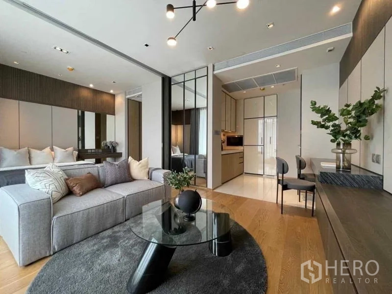Condominium for rent or sale - Open-plan 1-bedroom layout with sofa, kitchen and work desk.