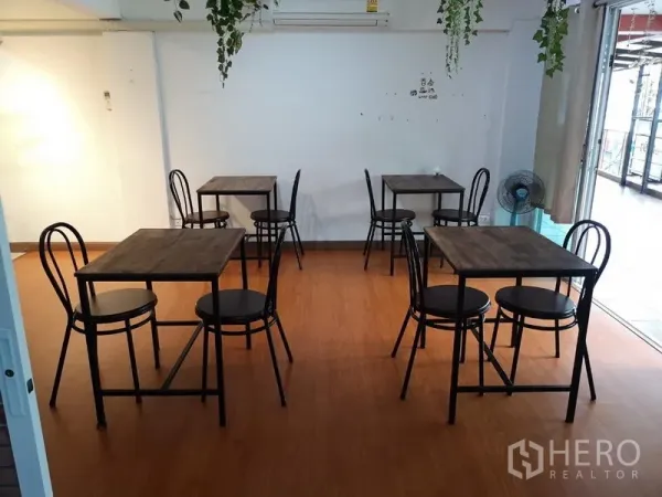 Retail Space for rent in Khlong Toei, Bangkok - Dining room with multiple two-seat tables and sliding glass door to terrace.