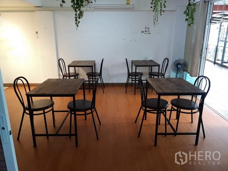 Retail Space for rent in Khlong Toei, Bangkok - Dining room with multiple two-seat tables and sliding glass door to terrace.