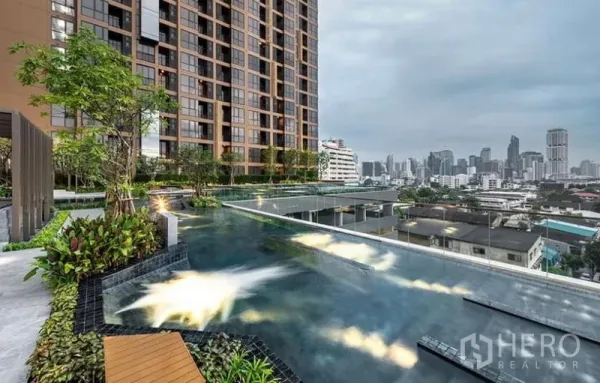 Condominium for rent - Elevated swimming pool with landscaped deck and wide Bangkok skyline views.