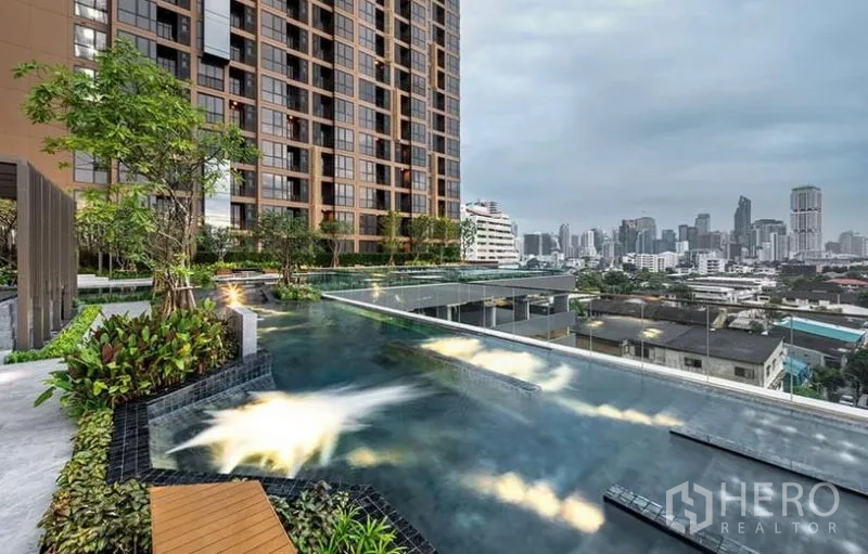 Condominium for rent - Elevated swimming pool with landscaped deck and wide Bangkok skyline views.