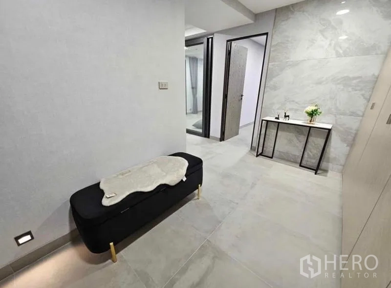 Condominium for rent or sale - Minimalist hallway with bench and console table.