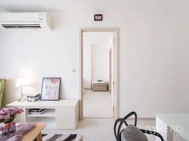 Condominium for sale in Khlong Toei, Bangkok - Doorway from living room to serene bedroom in neutral tones.