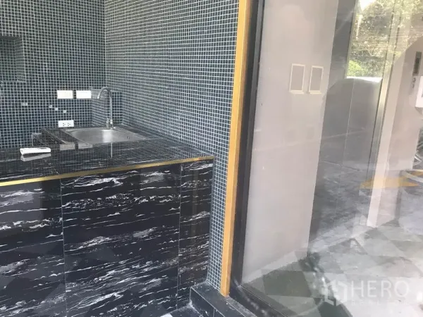 Retail Space for rent in Watthana, Bangkok - Close-up of stainless sink and black marble counter beside the glass entrance.