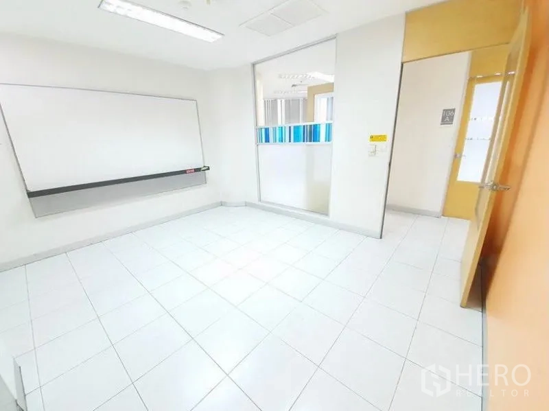 Office Space for rent in Bang Na, Bangkok - Bright office featuring a whiteboard, internal window and light wood door.