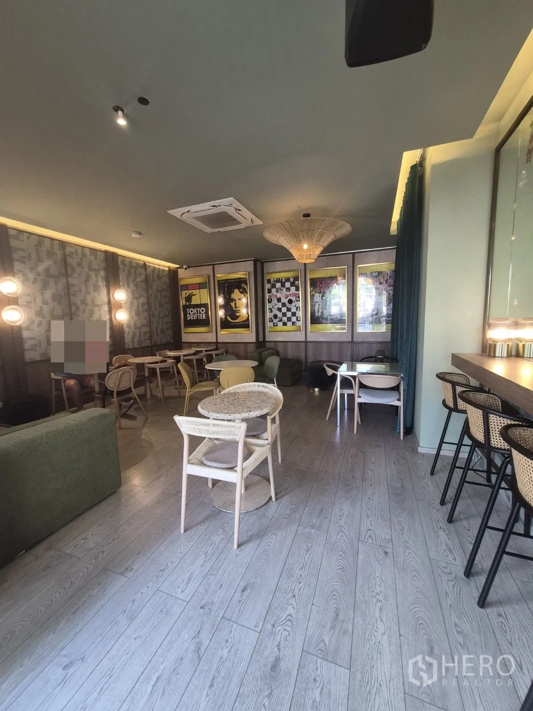 Retail Space for rent in Watthana, Bangkok - Open-plan seating area with round tables, bar counter, wood floors, and warm ambient lights.