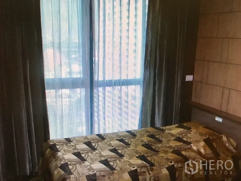 คอนโด ให้เช่าในRatchathewi, Bangkok - ห้องนอนที่สอง เตียงนอน หน้าต่างสูงจรดพื้น ม่านทึบ และวิวเมืองผ่านม่านโปร่ง
