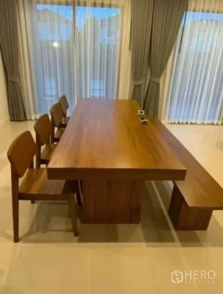 Detached House for rent - Solid wood dining table with chairs and a bench beside floor-to-ceiling curtains.