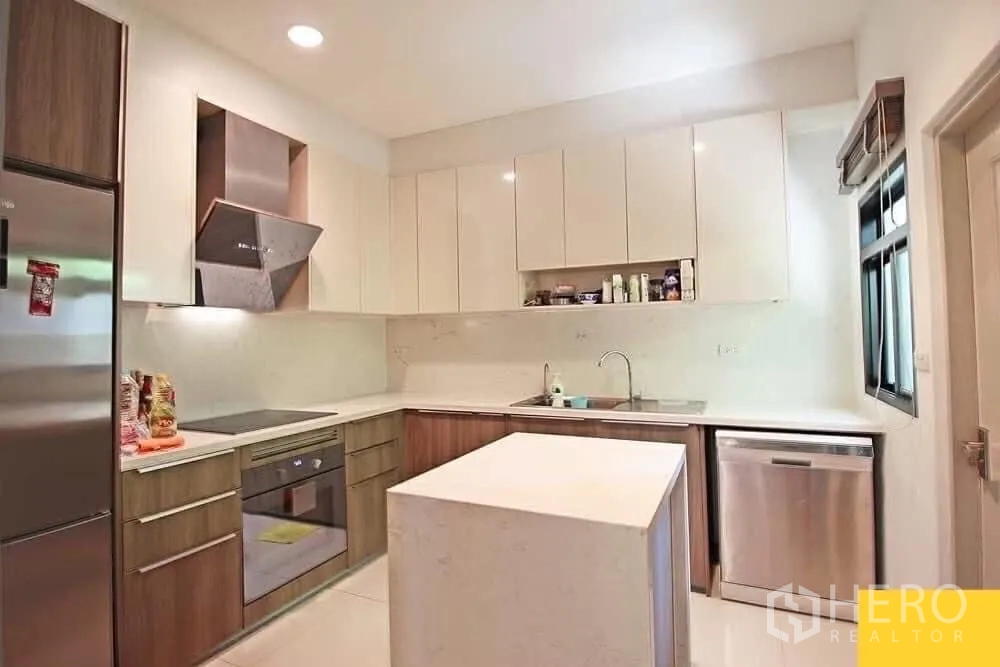 Detached House for rent in Bang Khae, Bangkok - Contemporary kitchen with island, oven, cooktop, dishwasher and ample cabinets.