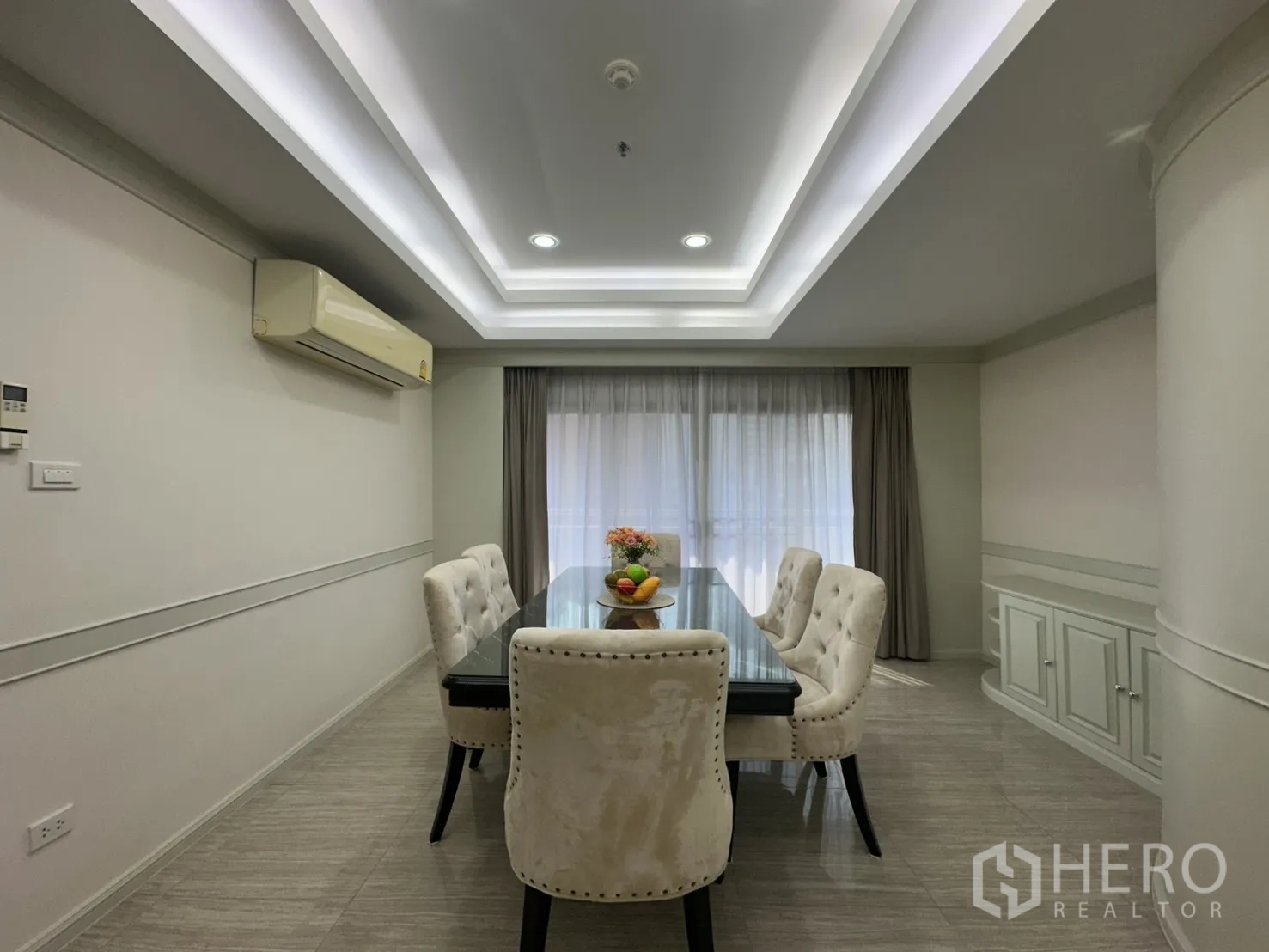 Condominium for rent in Watthana, Bangkok - Dining area with six upholstered chairs and soft natural light.