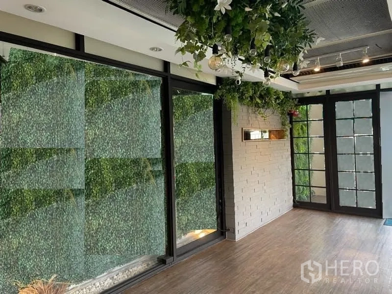 Retail Space for rent in Watthana, Bangkok - Corner retail space with large windows, decorative plant wall, French doors and hanging greenery.