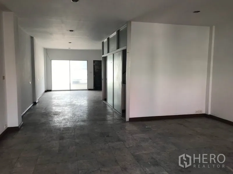 Office Space for rent in Khlong Toei, Bangkok - Long open-plan office floor with recessed lighting and partial glass partitions.
