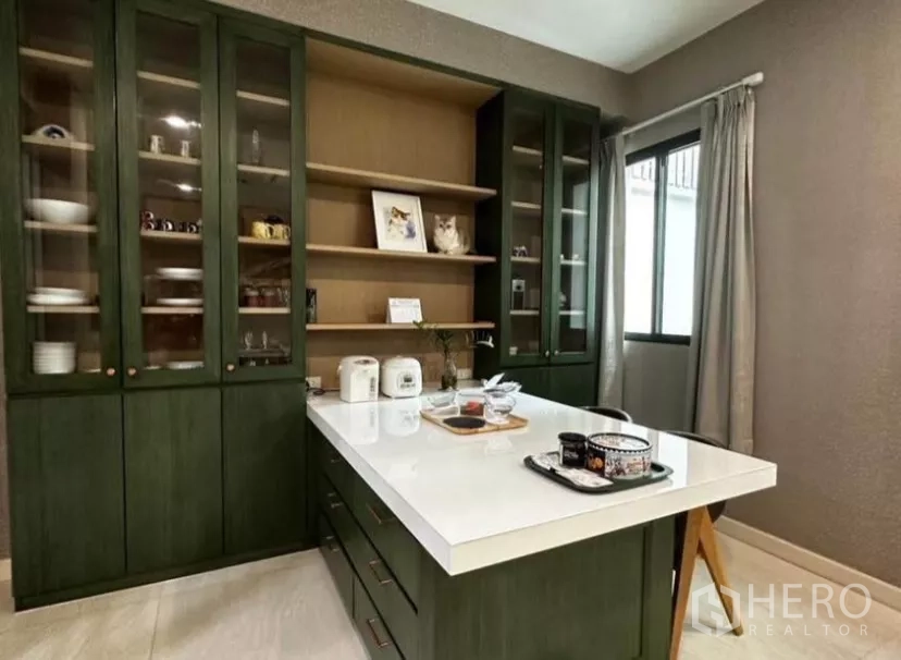 Townhouse for rent in Yan Nawa, Bangkok - Pantry kitchen with green shaker cabinets and a white quartz island.