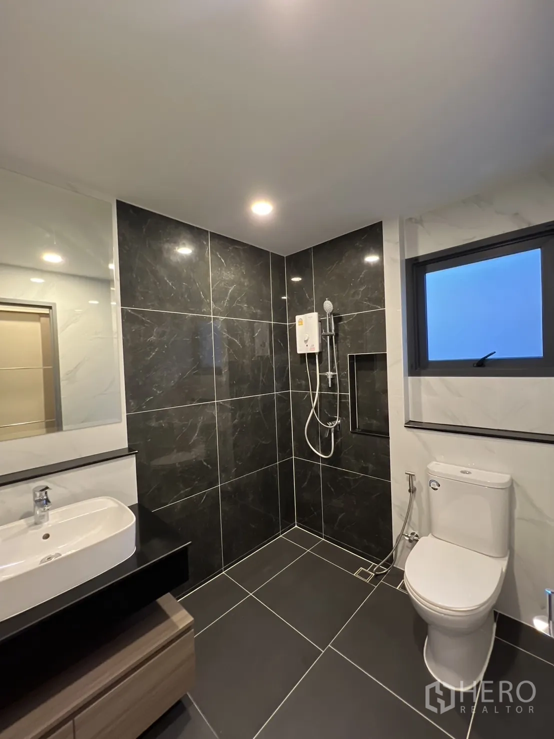 Detached House for rent in Bang Phli, Samut Prakan - Modern bathroom with black tiles, rainfall shower and window.