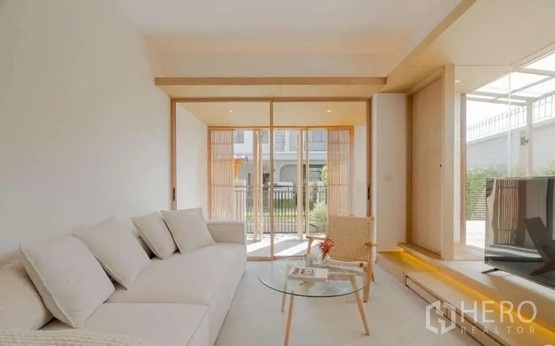 Detached House for sale in Bang Phli, Samut Prakan - Sunlit family lounge with floor-to-ceiling sliding doors to the patio and TV corner.