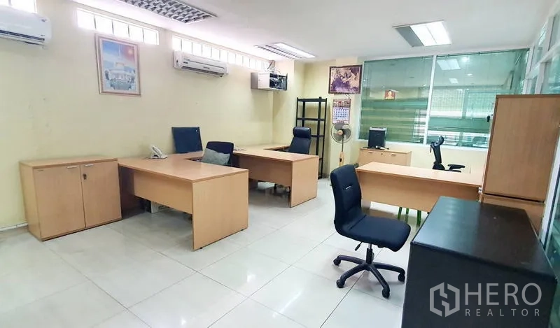 Office Space for rent in Bang Kho Laem, Bangkok - Team area with light wood desks, filing cabinets, ceiling lights and AC units.