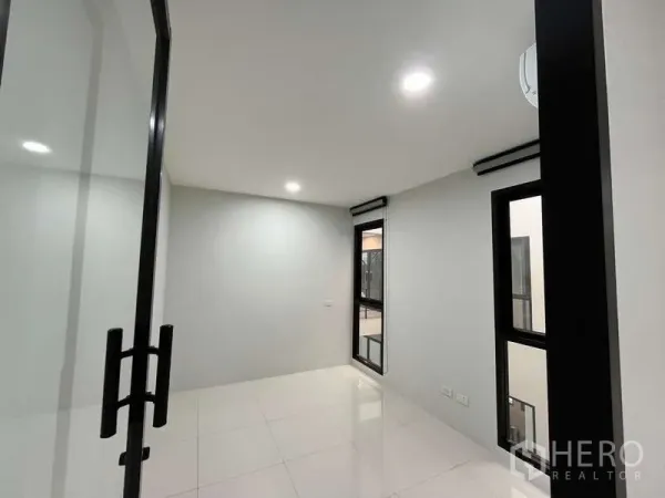 Office Space for rent in Prawet, Bangkok - Compact private office with glass door, windows and downlights for focused work.