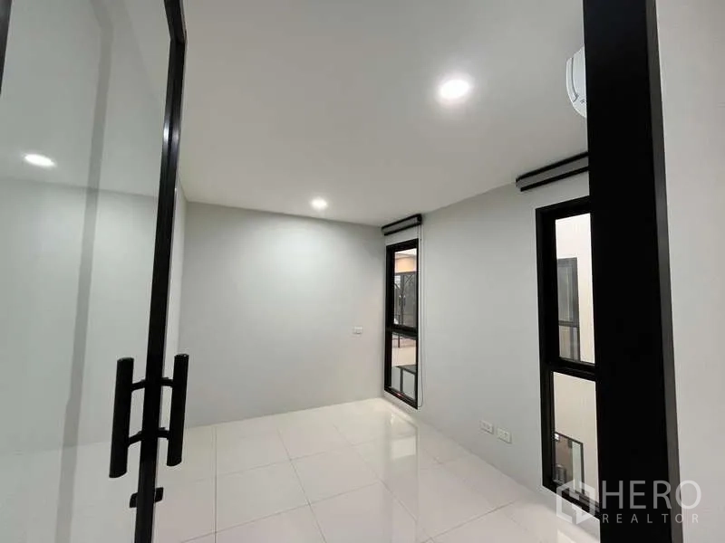Office Space for rent in Prawet, Bangkok - Compact private office with glass door, windows and downlights for focused work.