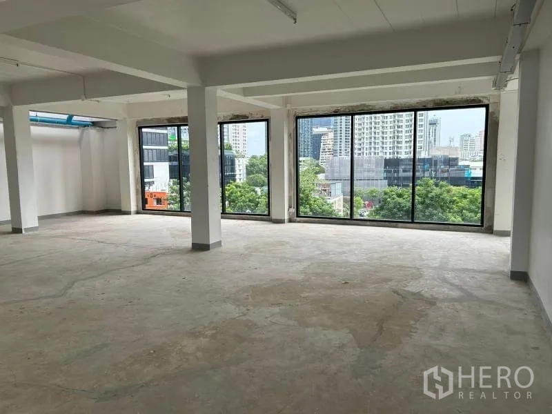 Office Space for rent in Bang Rak, Bangkok - Upper-floor workspace with panoramic city skyline through expansive windows.