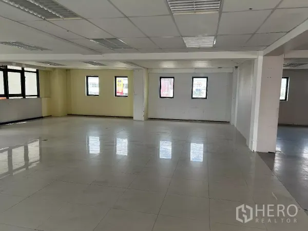 办公空间 出租在Din Daeng, Bangkok - 大型开放工作区，浅色瓷砖地、格栅灯和多扇窗户。