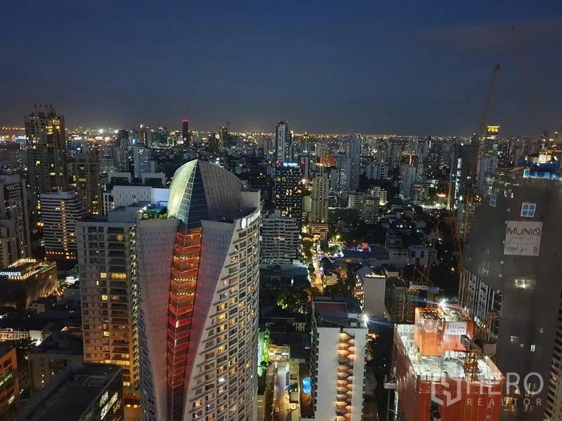 Condominium for rent in Watthana, Bangkok - High-rise Bangkok skyline at night viewed from the condo balcony near Asok.