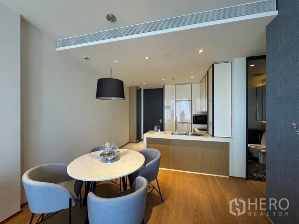 Condominium for rent - Open-plan dining and kitchen with pendant light and island counter.