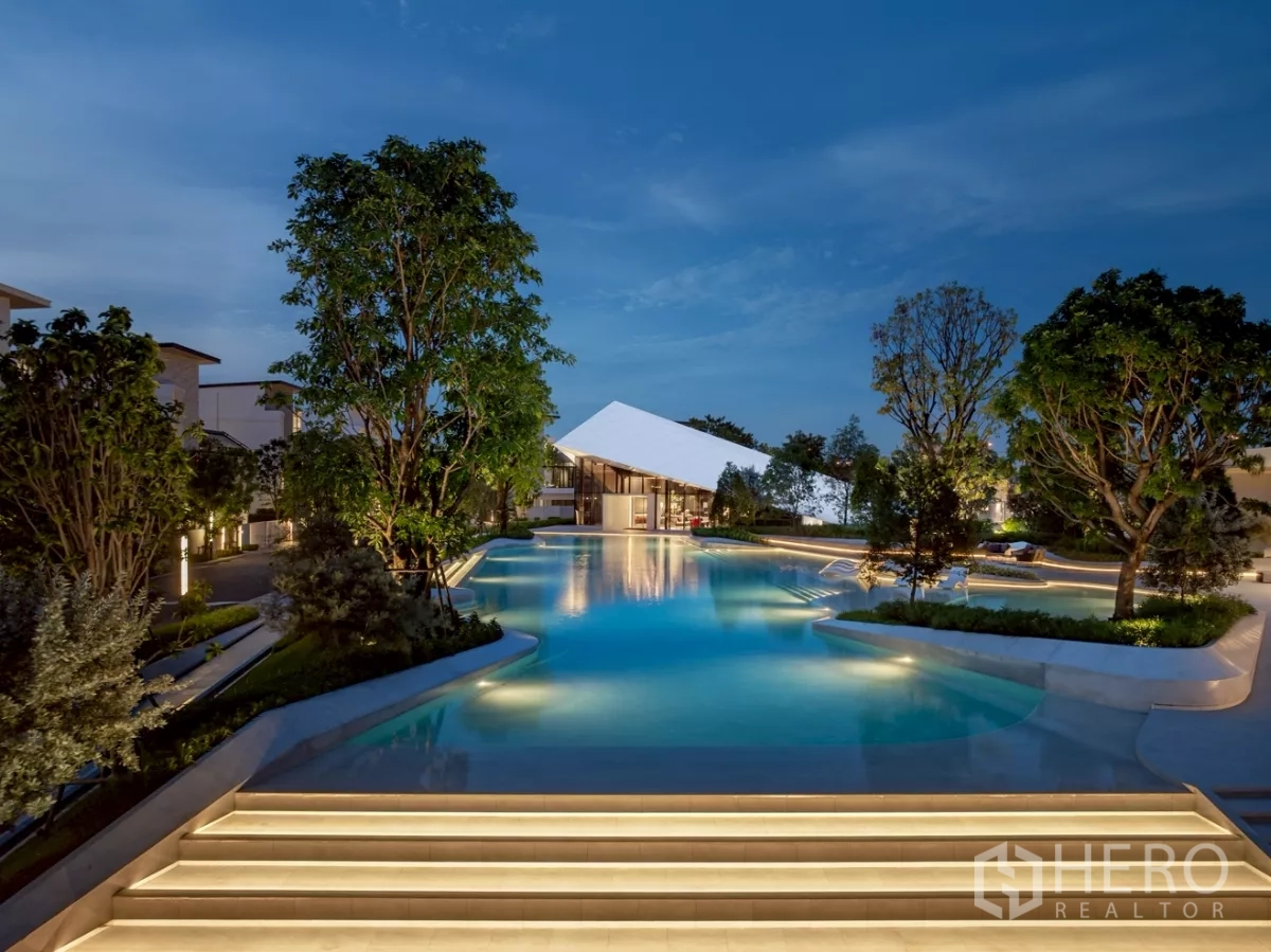 Detached House for rent in Saphan Sung, Bangkok - Community resort‑style swimming pool with landscaped gardens at dusk.