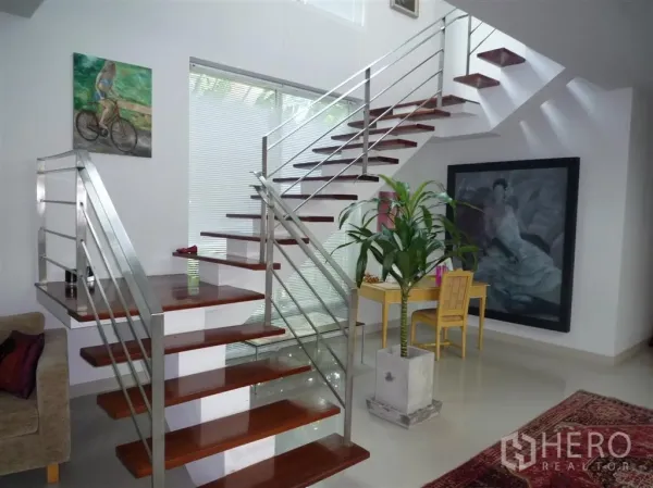 Detached House for rent in Khan Na Yao, Bangkok - Modern open staircase with wooden treads and steel rails beside a bright window.