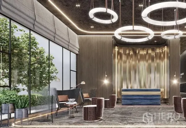 Condominium for sale in Khlong Toei, Bangkok - Luxurious condo lobby with circular chandeliers, floor‑to‑ceiling windows and lounge seating in Khlong Toei, Bangkok.