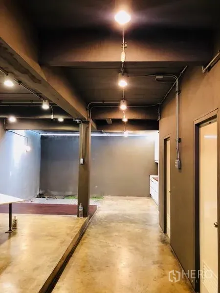 Home Office for rent in Huai Khwang, Bangkok - Open-plan ground floor corridor with exposed ceiling and pantry area.