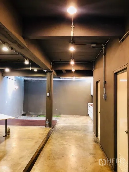 Home Office for rent in Huai Khwang, Bangkok - Open-plan ground floor corridor with exposed ceiling and pantry area.