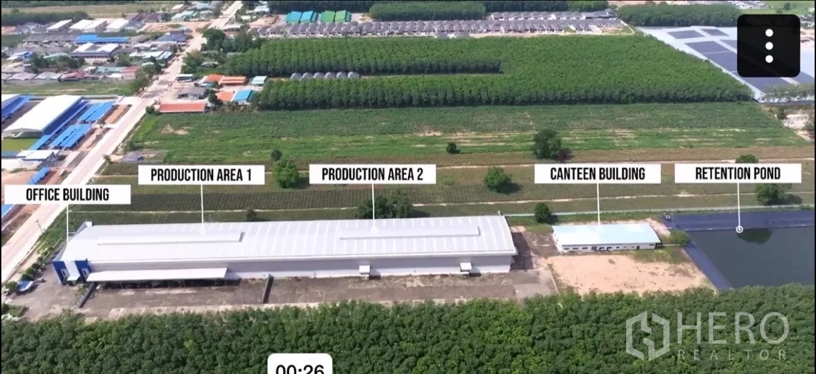 Factory for sale in Pluak Daeng, Rayong - Site overview showing front office building, two production halls, a canteen building, and a retention pond.