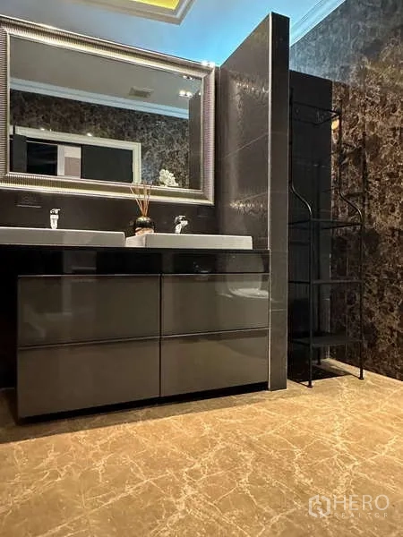 Condominium for rent or sale in Khlong Toei, Bangkok - Luxurious bathroom with double vanity, large framed mirror and marble-style walls and floors.