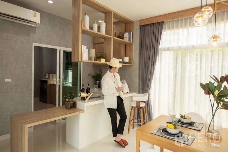 Detached House for sale in Lam Luk Ka, Pathum Thani - Open-plan dining and pantry with built-in shelving and large windows.