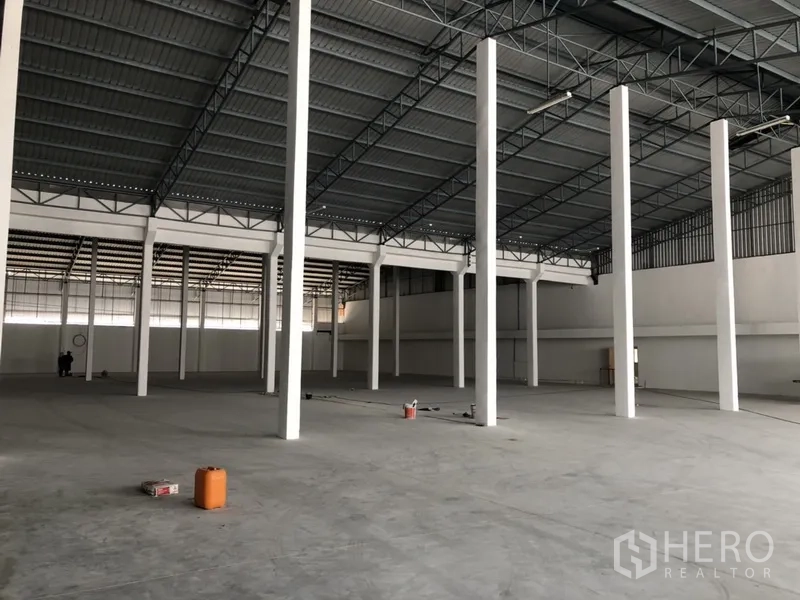 คลังสินค้า ให้เช่าในNonthaburi - ภายในโกดังมุมอื่น เน้นแนวเสาเป็นระเบียบและพื้นที่ชั้นลอย