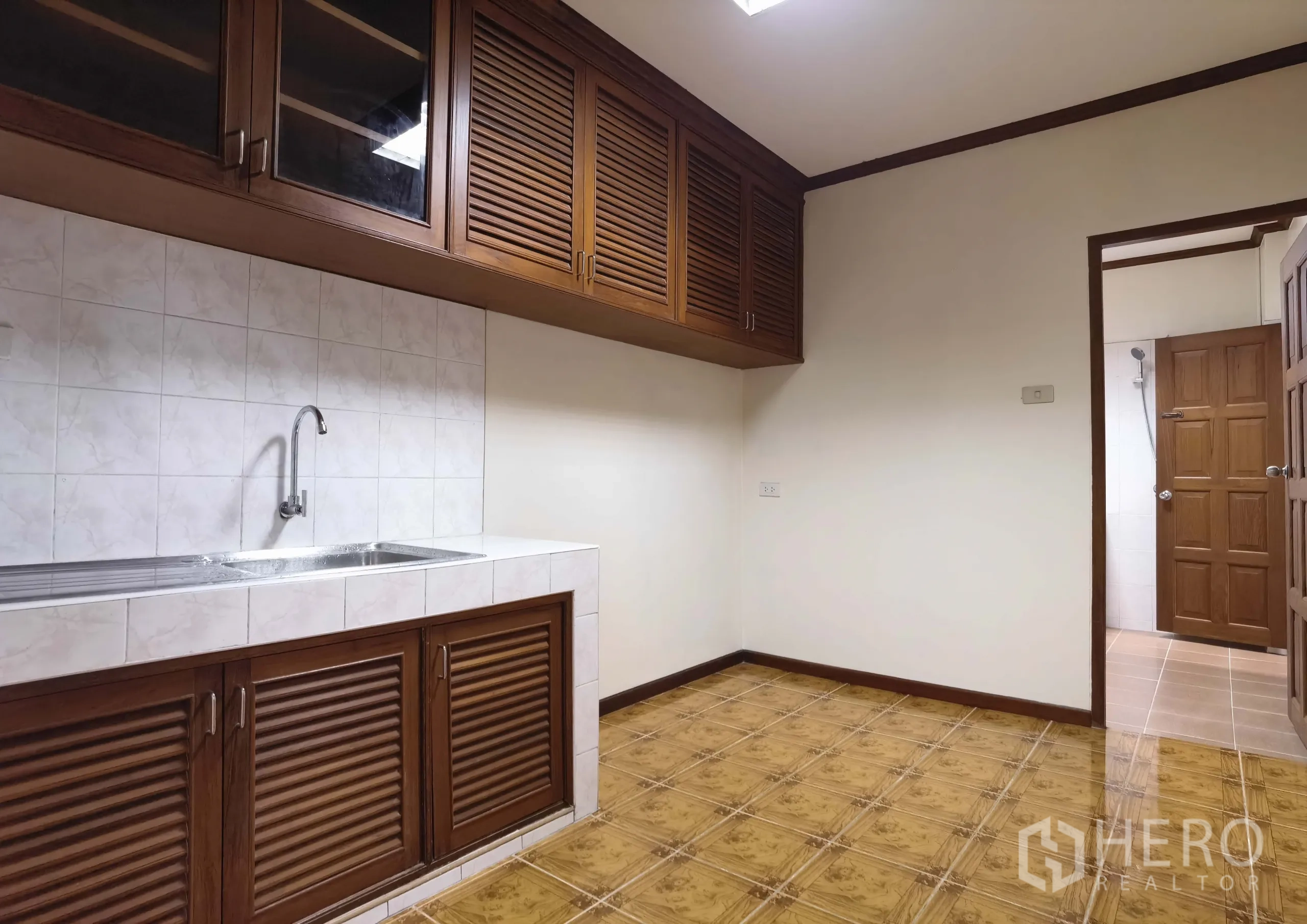 Warehouse for rent in Samut Prakan - Pantry with tiled backsplash, long stainless sink and wooden storage cabinets.