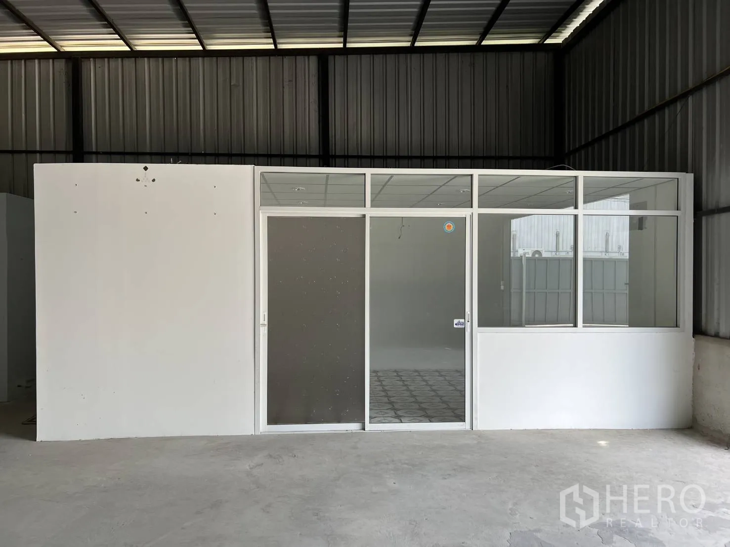 Warehouse for rent in Lat Krabang, Bangkok - Glass-front enclosed office inside the warehouse with sliding door and windows.