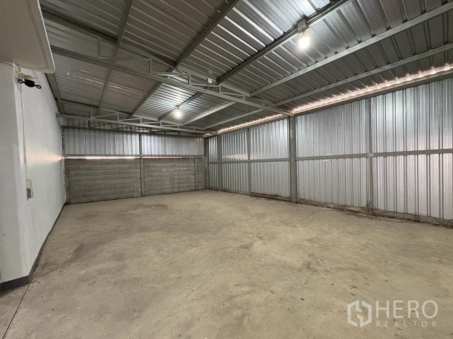Warehouse for rent in Bang Na, Bangkok - Enclosed loading or storage bay with metal walls and a door.