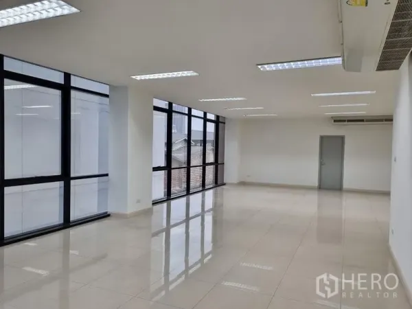 Office Space for rent in Bang Kho Laem, Bangkok - Spacious rectangular office interior featuring large glass windows, air-conditioning and polished tiles with a potential meeting room door.