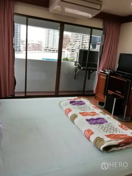 公寓 出租或出售在Watthana, Bangkok - 卧室带推拉门通往阳台，近景城景，可步行到BTS娜娜站。
