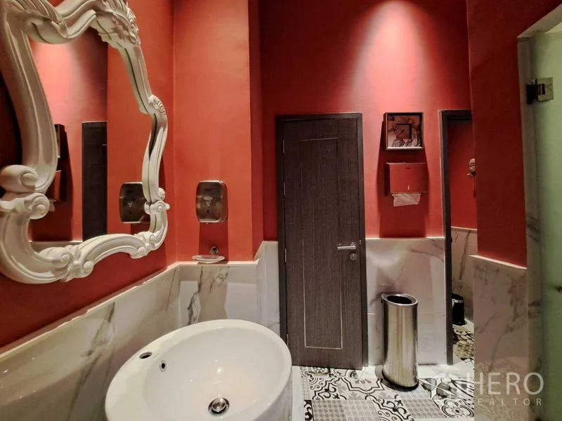 Retail Space for rent in Watthana, Bangkok - Stylish restroom with red walls, marble wainscot, ornate mirror and round basin.