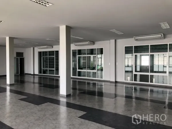 Factory for rent or sale in Bang Phli, Samut Prakan - Open-plan office with glass partitions, air-conditioning units, and tiled flooring.
