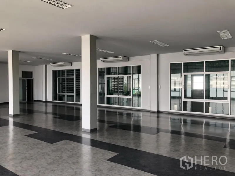 Factory for rent or sale in Bang Phli, Samut Prakan - Open-plan office with glass partitions, air-conditioning units, and tiled flooring.