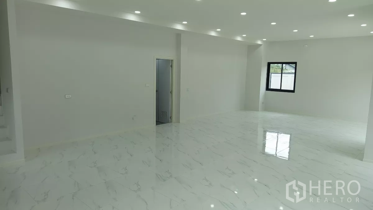 Warehouse for rent or sale in Lam Luk Ka, Pathum Thani - Spacious office hall with glossy tiles, white walls, and ceiling spotlights.