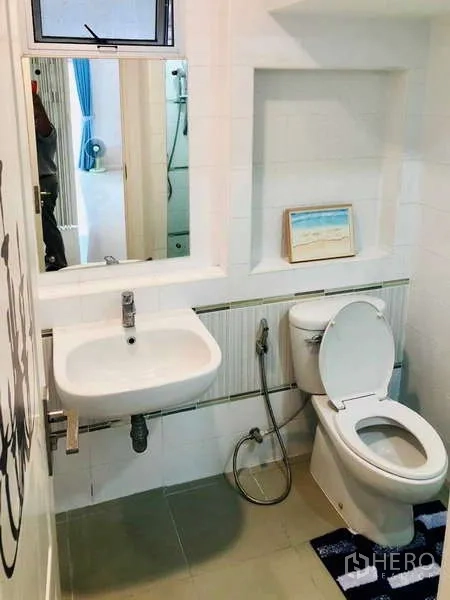 Detached House for rent or sale - Bright bathroom with white tiles, wall mirror, sink and toilet.