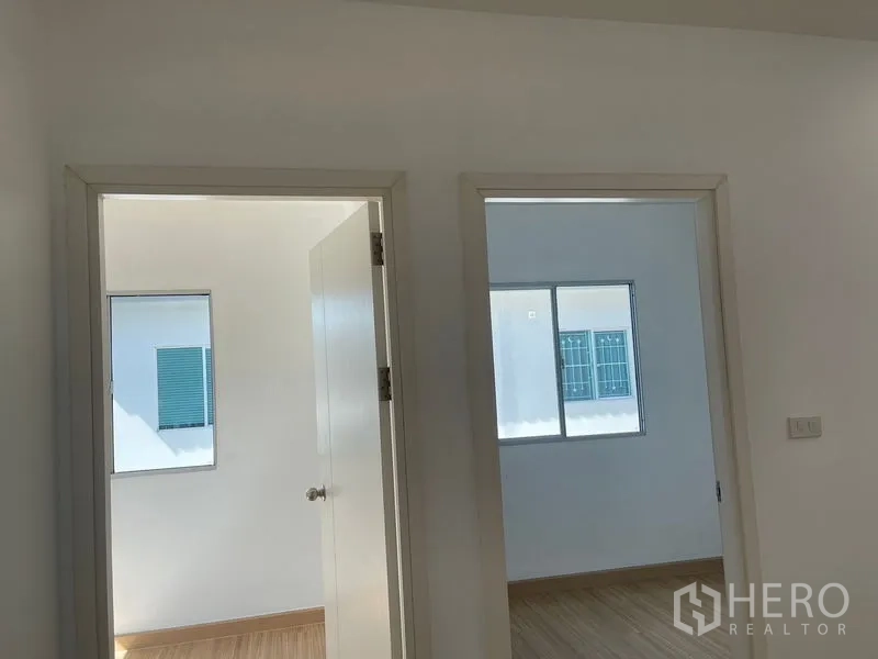 Townhouse for sale - Two adjacent bedroom doorways off the upstairs corridor