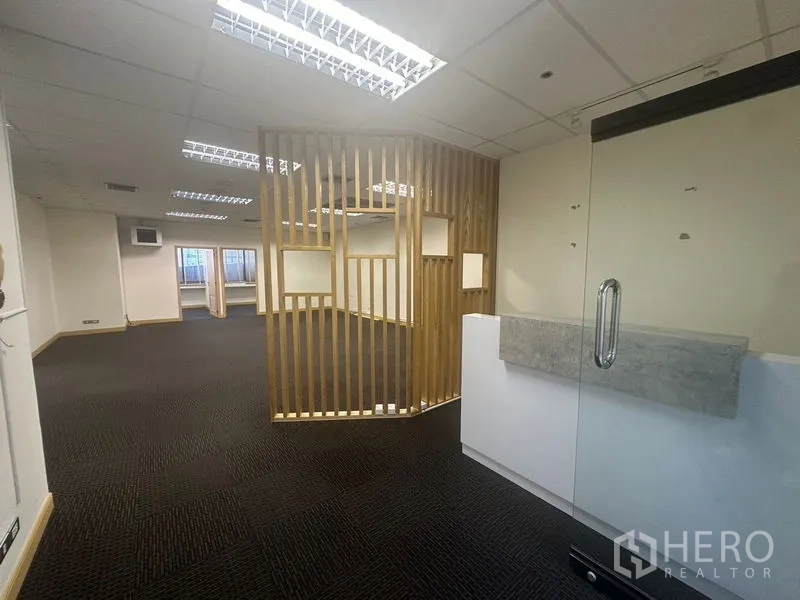 Office Space for rent in Bang Na, Bangkok - Reception entry with a glass door and wooden screen leading to the open office.