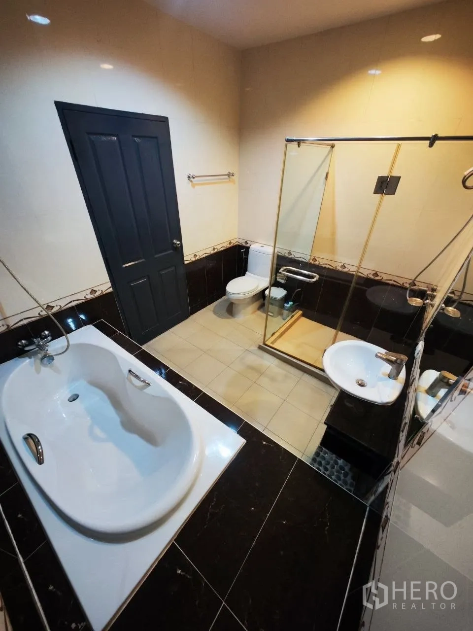 Home Office for rent in Bang Na, Bangkok - Modern bathroom with bathtub, glass shower, vanity and toilet.